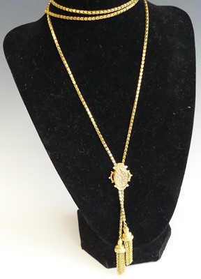 Lot 2337 - A yellow metal Lariat style long guard chain,...