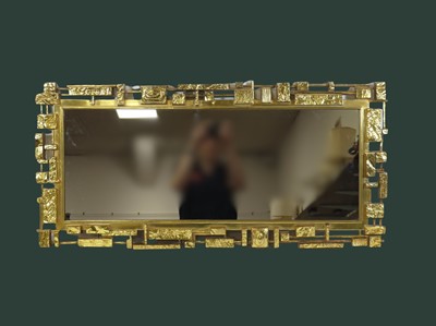 Lot 443 - A Syroco brutalist wall mirror, of moulded...