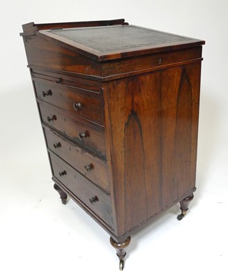 Lot 2598 - A Regency rosewood slide-top Davenport, having...