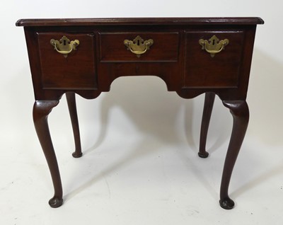 Lot 2604 - A George III mahogany lowboy, the one-piece...