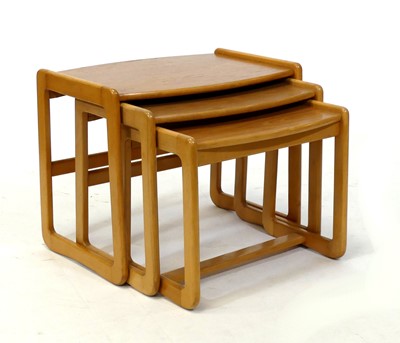 Lot 389 - A 1970s teak and beech nest of three...