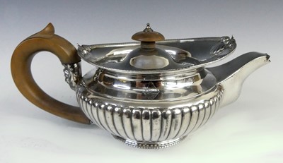 Lot 2126 - A George III silver teapot, of compressed...