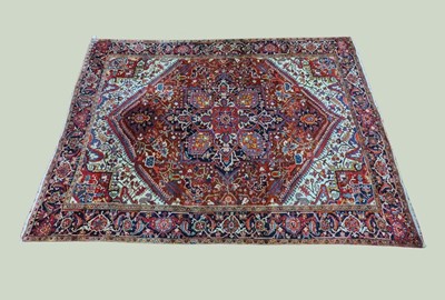 Lot 2569 - A Persian Heriz woollen carpet, the central...