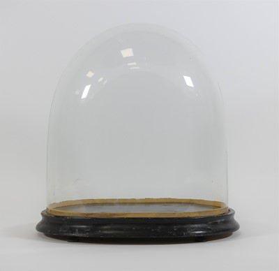 Lot 11 - A Victorian glass dome, upon an ebonised...