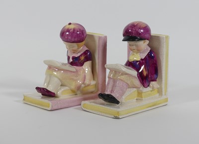 Lot 37 - A pair of figural pottery bookends, each in...