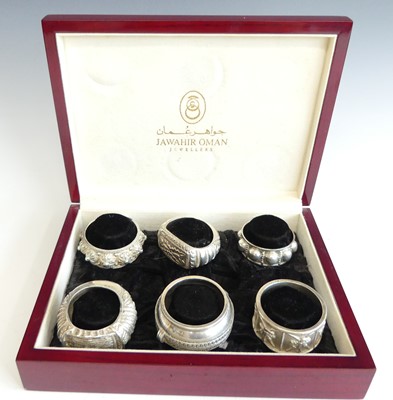 Lot 2196 - A cased set of six Omani silver napkin rings...