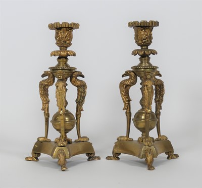 Lot 105 - A pair of brass table candlesticks, upon three...