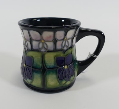 Lot 159 - A Moorcroft pottery mug, tube-line decorated...