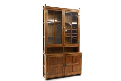 Lot 1131 - A late Victorian pitch pine bookcase cupboard,...