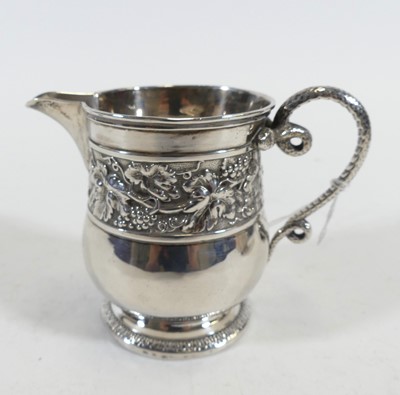 Lot 234 - A William IV silver milk jug, relief decorated...