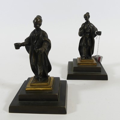 Lot 183 - A pair of bronze figures, each mounted upon...