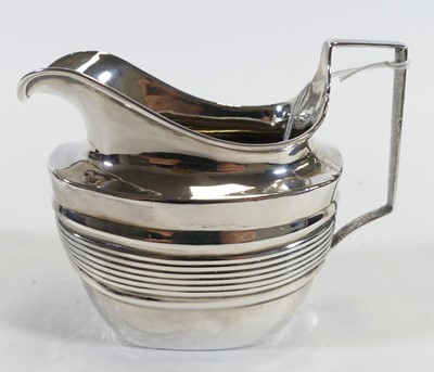 Lot 220 - A silver milk jug, having bands of reeded...