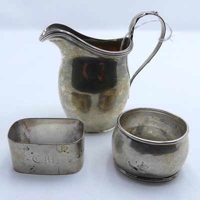 Lot 270 - A George V silver cream jug; together with two...