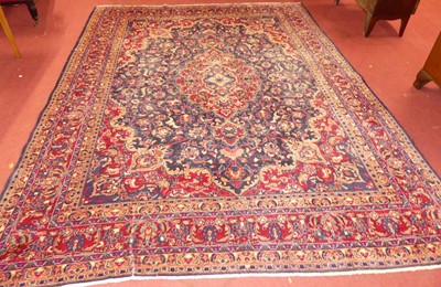 Lot 1139 - A large Persian woollen red ground Tabriz rug,...