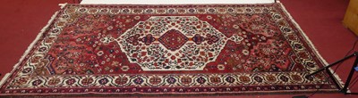 Lot 1142 - A Persian woollen red ground Heriz rug, 304 x...