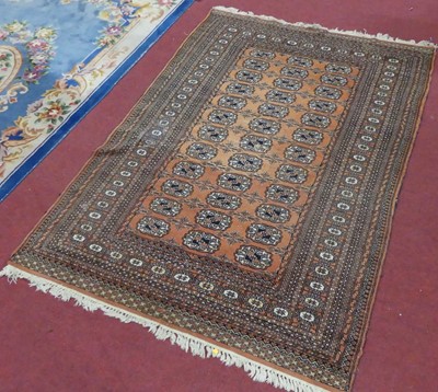 Lot 1144 - A Persian woollen rust ground Bokhara rug, 180...