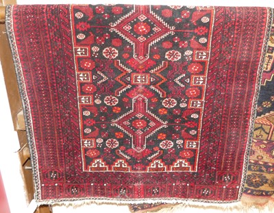 Lot 1150 - An Afghan woollen red ground rug; together...