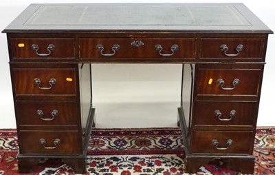 Lot 1181 - A reproduction mahogany and gilt tooled green...