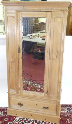 Lot 1195 - A pine single mirror door wardrobe, having...