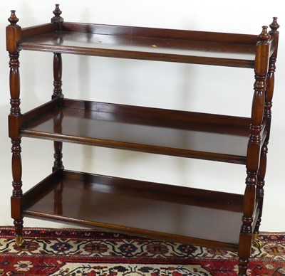 Lot 1198 - A mahogany three-tier buffet whatnot, raised...