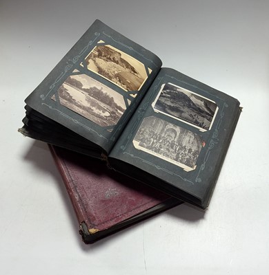 Lot 484 - An early 20th century postcard album,...