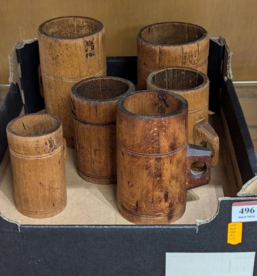 Lot 496 - A graduated set of six wooden mugs, the...