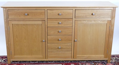 Lot 1226 - A contemporary blond oak sideboard, fitted...