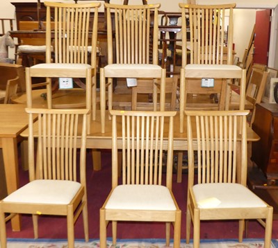 Lot 1246 - A contemporary Ercol blond oak dining suite,...