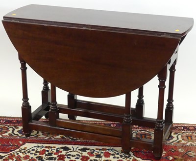 Lot 1247 - A joined walnut drop leaf table, having...