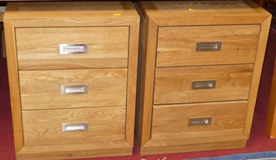 Lot 1251 - A pair of contemporary blond oak three-drawer...