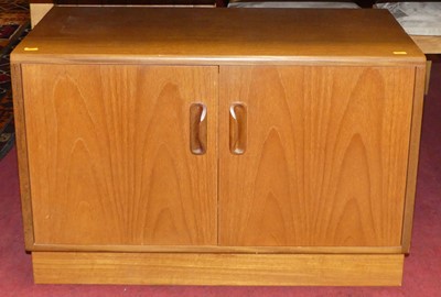 Lot 1252 - A G-Plan teak low two-door side cupboard,...