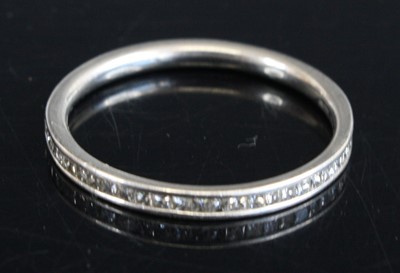 Lot 305 - A modern platinum diamond half eternity ring,...