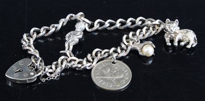 Lot 306 - A white metal curblink charm bracelet, having...