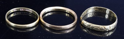 Lot 335 - A 22ct gold wedding band, size O; together...