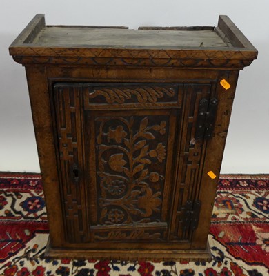 Lot 1309 - A joined and blind carved oak single door...