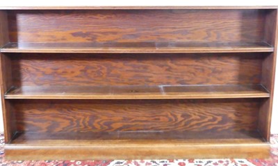 Lot 1319 - A walnut long dwarf open bookshelf, width 168cm