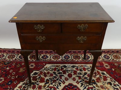 Lot 1320 - A George III oak three-drawer lowboy, raised...