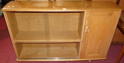 Lot 1327 - An elm low bookshelf, having twin glazed...