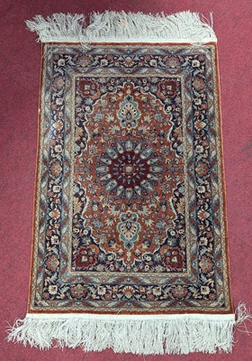 Lot 2610 - A Persian Kum silk prayer rug, having a rust...