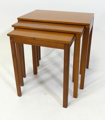 Lot 395 - A 1970s teak nest of three occasional tables...