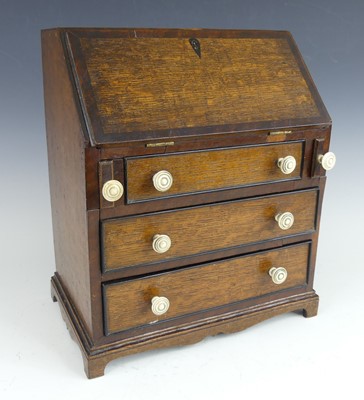 Lot 2418 - A late Georgian oak and mahogany crossbanded...