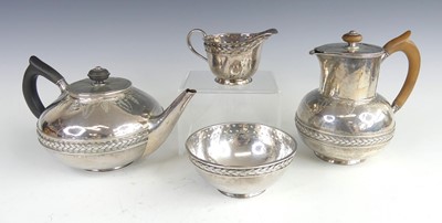 Lot 121 - A late Arts & Crafts silver four piece tea and...