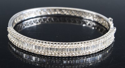 Lot 2329 - An 18ct white gold diamond hinged oval...