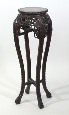 Lot 2454 - A Chinese rosewood jardiniere stand, having a...