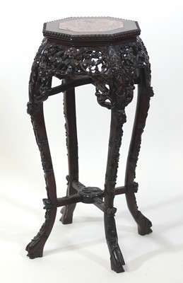 Lot 2455 - A Chinese rosewood jardiniere stand, having a...