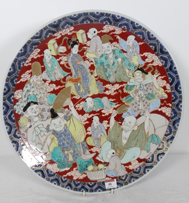 Lot 48 - A Japanese porcelain charger, enamel decorated...