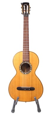 Lot 656 - An acoustic parlour guitar having a walnut...