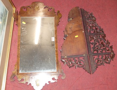 Lot 1149 - A yew wood fret-cut wall mirror in the...