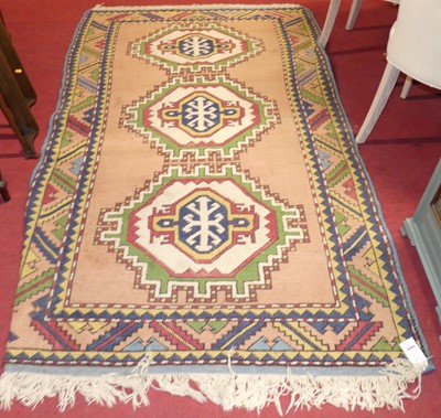 Lot 1163 - A Turkish woollen pink ground Kazak rug,...