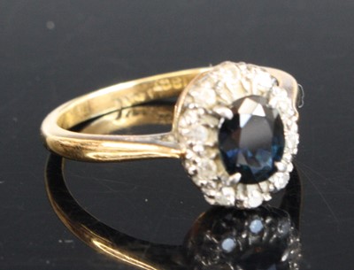 Lot 2553 - An 18ct gold sapphire and diamond oval cluster...